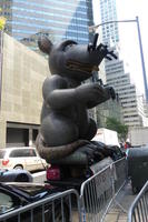 Large inflated rat on car with sign “Asbestos Kills”