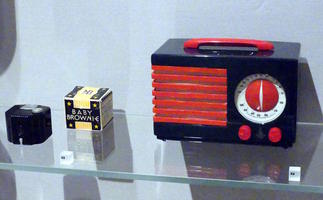 “Baby Brownie” camera and old red and black plastic desk radio