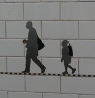 Silhouette of adult and child with backpack