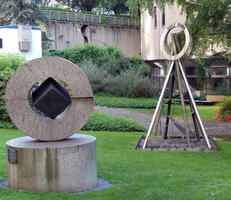 Abstract circular sculpture with cube in hole in center
