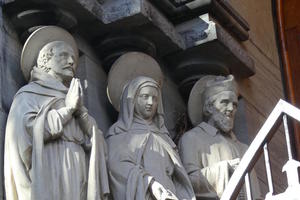 Sculpture of three saint-like figures on church