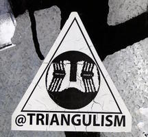 Triangular sticker with @triangulism at bottom