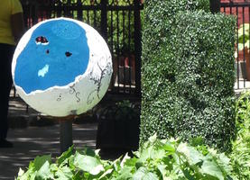 Sculpture of broken sphere; white outside and blue inside