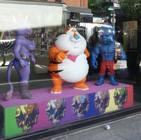 Purple cow, obese Tony the Tiger, and blue hulk-like figure