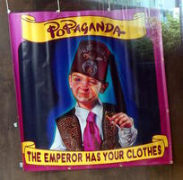 Child in shriner's fez, holding cigarette; “Popaganda- The Emperor Has Your Clothes”