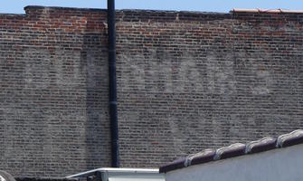 Faded paint on brickwork possibly reading “Bohnham's”