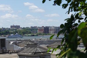 view across river from Highline; boat on river