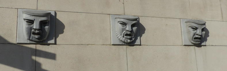 sculpted faces on wall