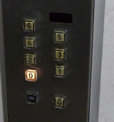 Elevator control panel showing floor zero lit up