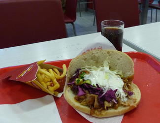 Chicken döner sandwich, french fries, and coke