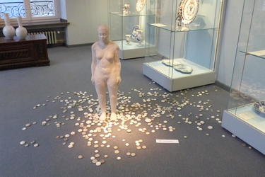 ceramic nude surrounded by small stones
