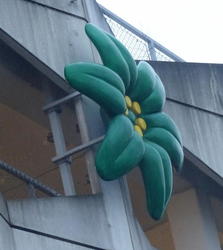 green flower on parking garage