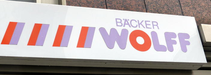 Sign for “Baker Wolff”, with O in red and other letters in light blue