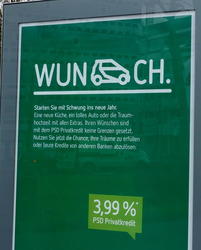 Word “Wunsch” (Wish) with a smart car in place of the S; advert for a loan company.