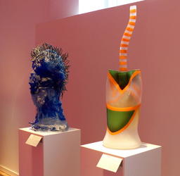 Blue head on left; greeen “juice box” with orange straw on right