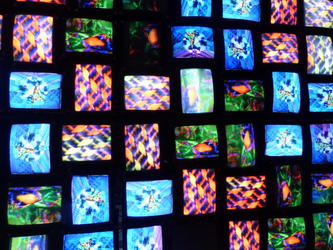 Mutiple TVs on ceiling with rapidly shifting images.
