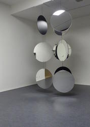 Large circular mirrors hanging from ceiling.