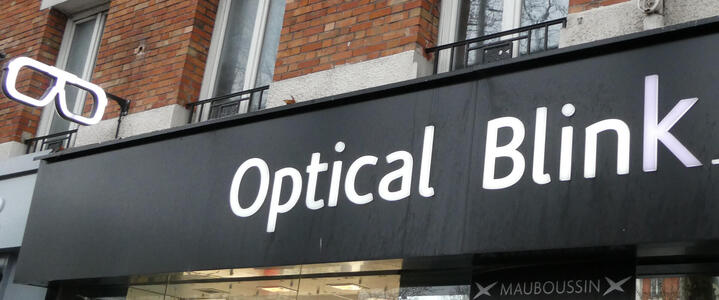 Sign: Optical Blink; at left is a three-d pair of glasses at right angles to the sign.