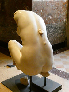 Sculpture of seated naked woman; hand-shaped piece of marble on back of sculpture