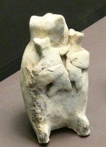 Crude sculptue of bear holding two cubs