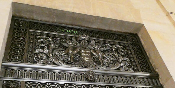 greek god metalwork on lintel