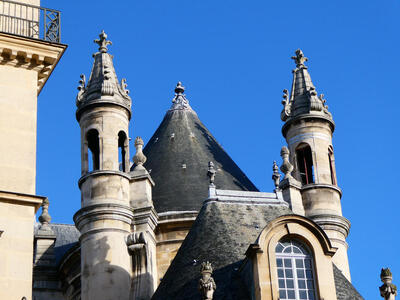 towers on building near louvre