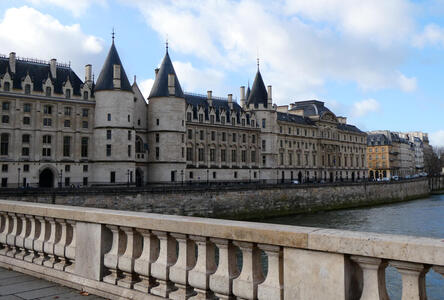 View of building with conical towers from a bridge across Seine river