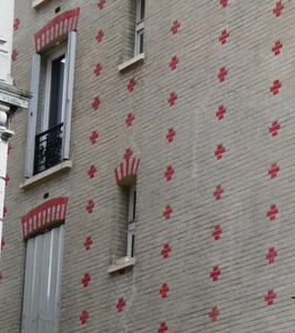 Building with pattern of small red crosses