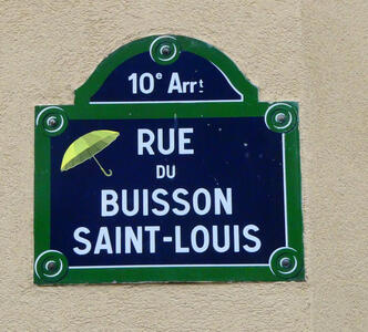 Drawing of umbrella on street sign for Rue du Buisson Saint-Louis