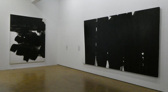 two paintings with black smears