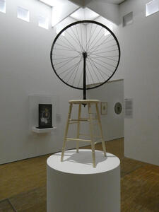 bicycle wheel on four legged stool