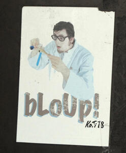 Chemist with glasses pouring liquid into test tube. Text on sticker reads “bloop!”
