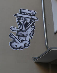 cartoon man in hat on side of building