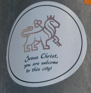 Jesus Christ, you are welcome to this city (drawing of lion with crown holding a key)