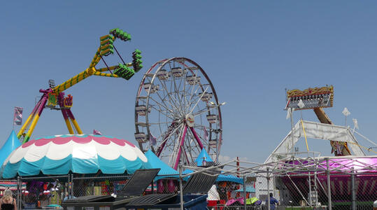 Ferris wheel and two carnival rides that swing people through the air.
