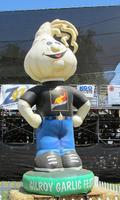 Large (3 m.) inflated figure with garlic bulb for head, wearing t-shirt jeans, and sneakers.