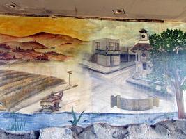 Portion of mural; garlic field at left, downtown at right