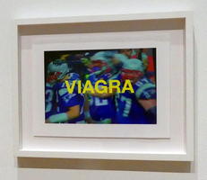 Photo of football players overlaid with VIAGRA in large yellow letters
