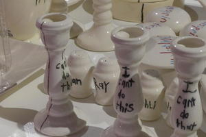 Candlesticks and salt shakers with writing on them: I can’t do this / Man / Ray