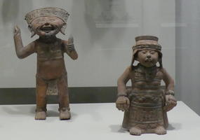 Terra cotta laughing man and standing woman
