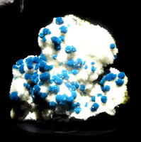 Small blue crystals on white crystalline rock