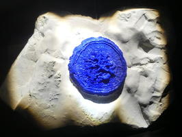 Circular blue crystal on white rock