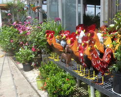 Ceramic pink flamingos and roosters outside a garden supply store
