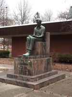 Statue of Abraham Lincoln as young man, seated, reading a book