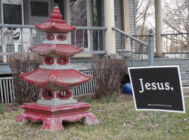 Red Chinese pagoda on left; yard sign with “Jesus.” at right.