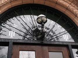 Old-style domed lamp in front of Mathematics building arch over door