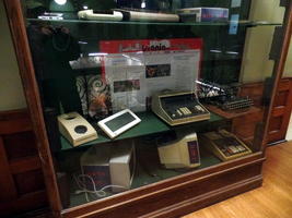 Display case showing old computers and calculatig equipment