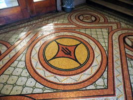 Mosaic on floor with University of Illinois symbol in middle