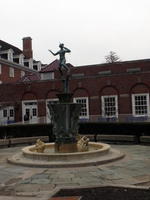 Sculpture of standing woman above a fountain