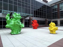 Green, red, and yellow sculptures in shapes like Play-Doh (TM)